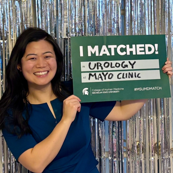 Susanna Wang holding her match day sign.